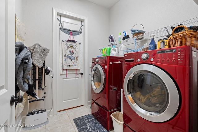 laundry room featuring separate washer and dryer and light tile patterned floors