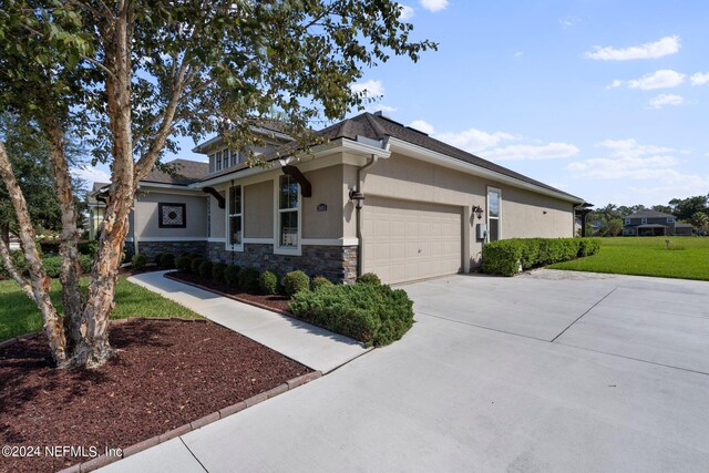 view of front of house with a front yard and a garage