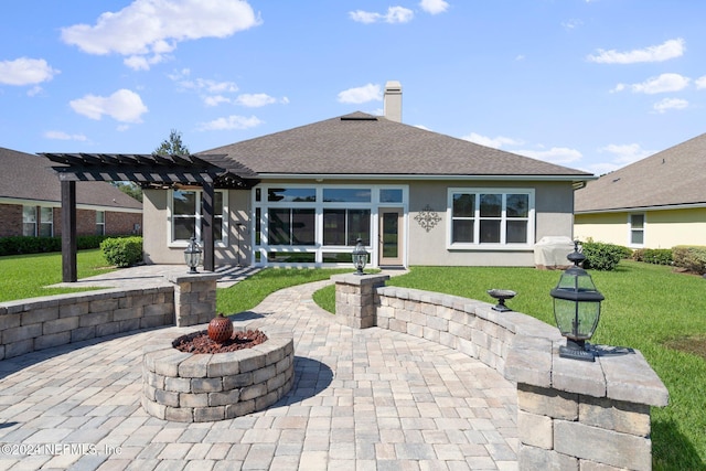 back of property featuring a patio, a pergola, and a yard