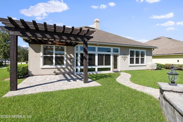 back of property featuring a yard, a patio, and a pergola