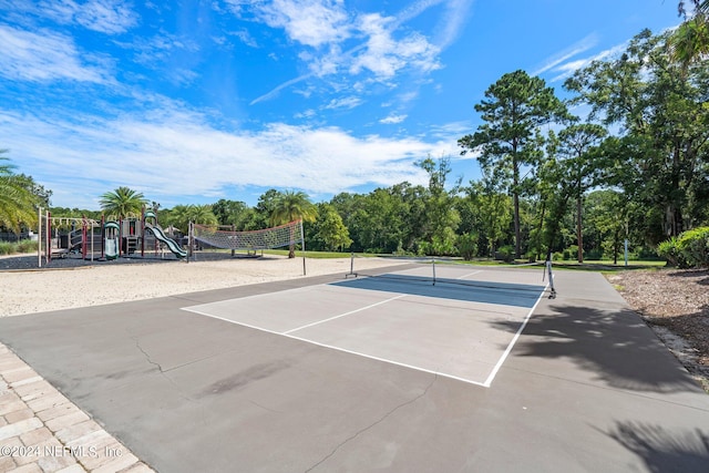 view of tennis court with a playground and volleyball court