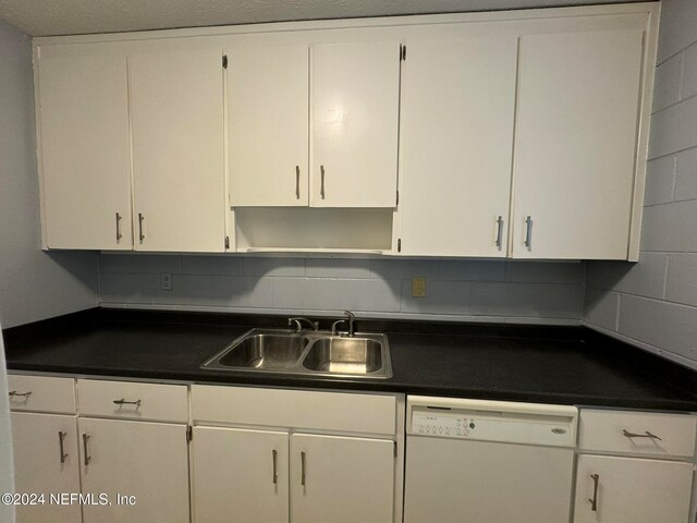 kitchen featuring sink, tasteful backsplash, white cabinetry, and dishwasher