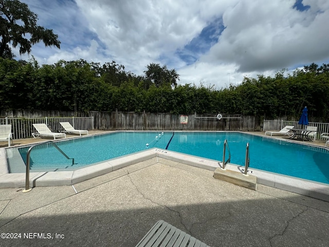 view of swimming pool featuring a patio area