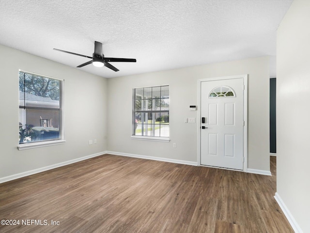 entryway featuring a textured ceiling, hardwood / wood-style flooring, and ceiling fan