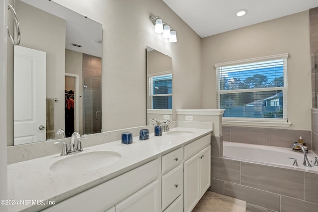 bathroom with vanity and independent shower and bath