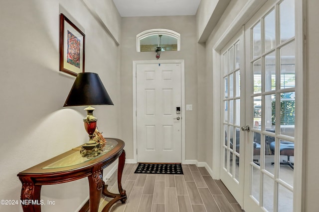 foyer with french doors and hardwood / wood-style floors