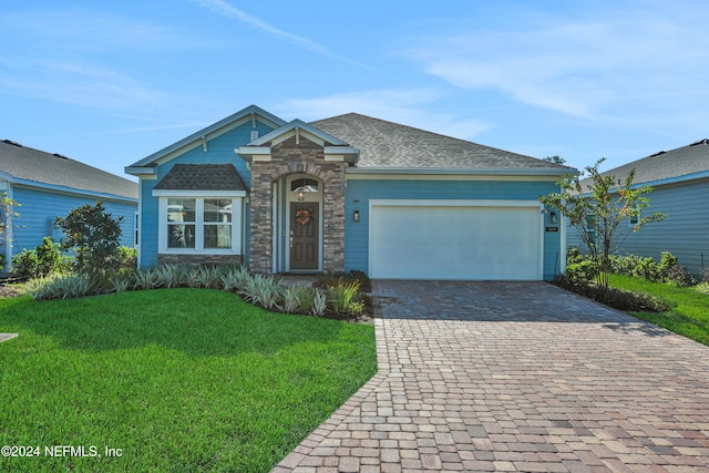 view of front facade with a garage and a front lawn