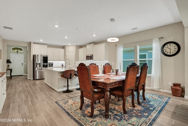 dining area featuring light hardwood / wood-style floors and sink