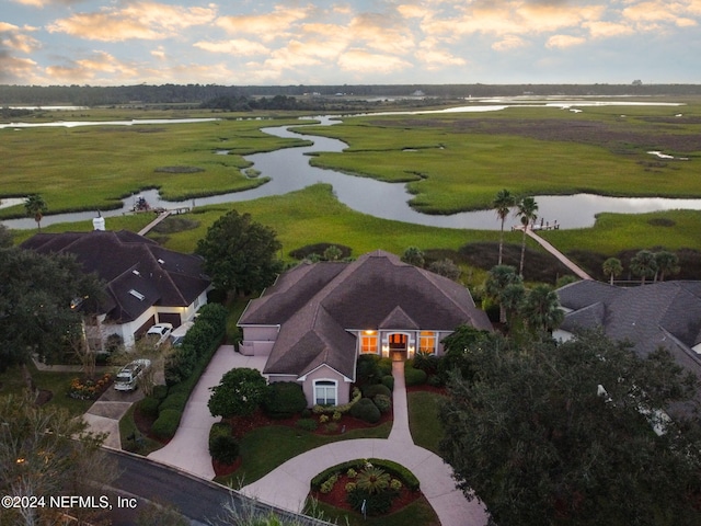 aerial view at dusk with a water view