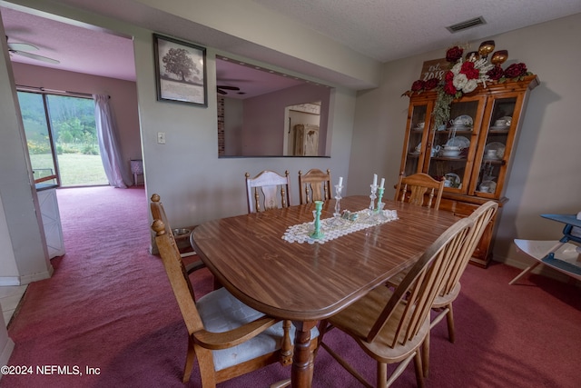 dining room with a textured ceiling, carpet floors, and ceiling fan