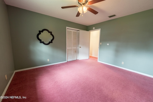 unfurnished bedroom with carpet, ceiling fan, and a closet