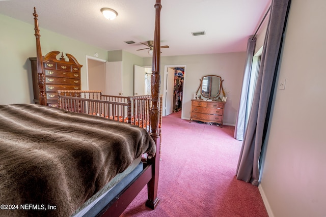 bedroom with a walk in closet, carpet floors, and a closet