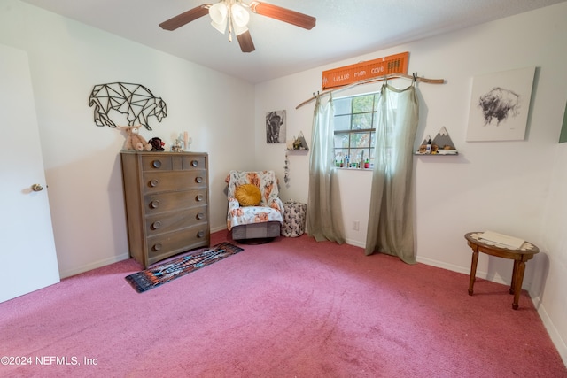 sitting room featuring ceiling fan and carpet floors