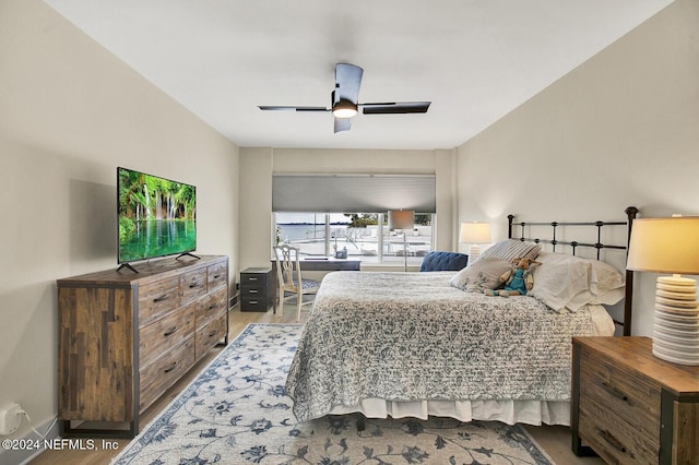 bedroom with a ceiling fan and wood finished floors