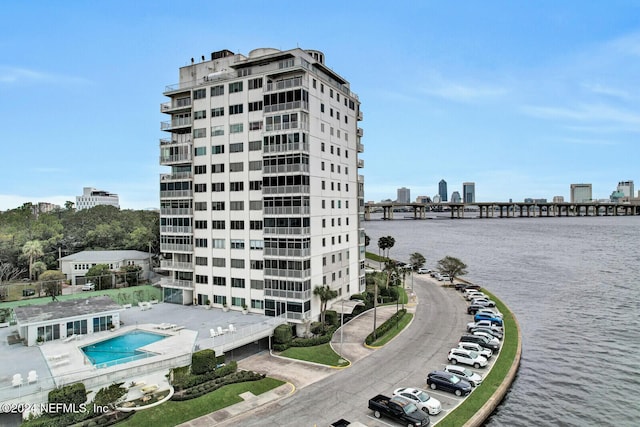 view of building exterior with a city view and a water view