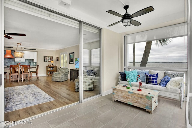 tiled living room featuring ceiling fan