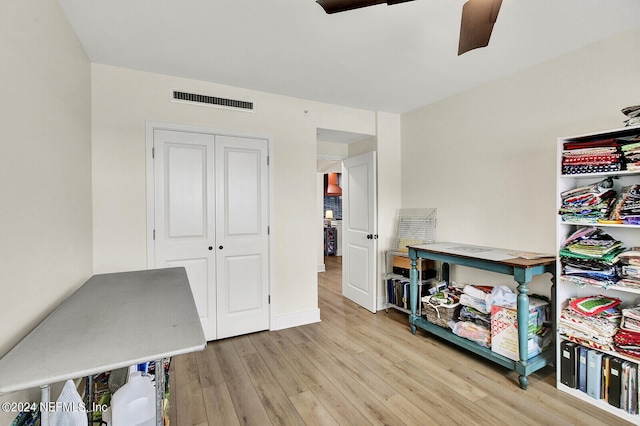 interior space featuring light wood-type flooring, baseboards, a ceiling fan, and visible vents