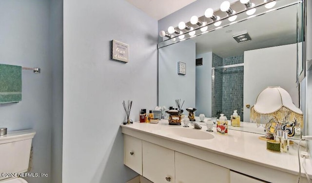 full bath with a shower stall, toilet, and vanity