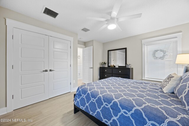 bedroom with wood-type flooring, a closet, and ceiling fan