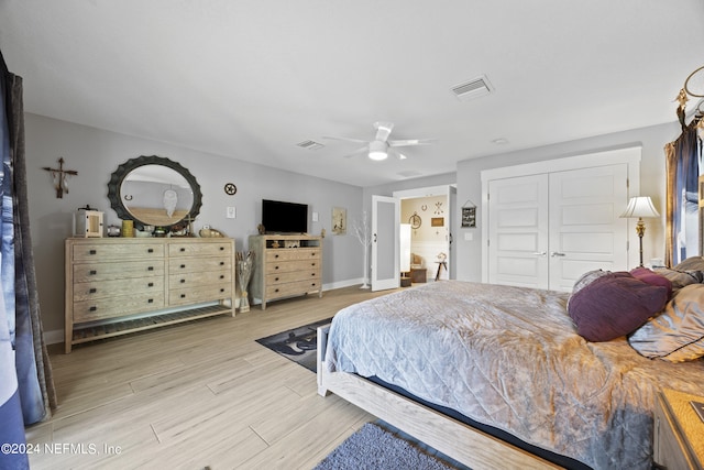 bedroom with light hardwood / wood-style flooring, a closet, and ceiling fan