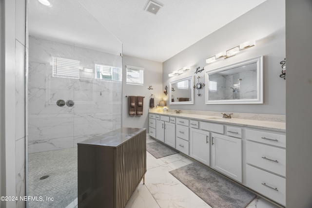 bathroom featuring vanity and a tile shower