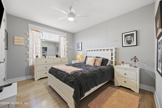 bedroom with ceiling fan and light wood-type flooring