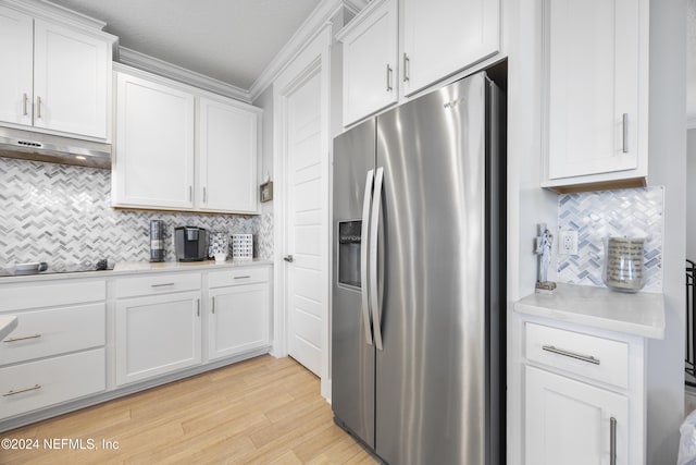 kitchen with stainless steel fridge, white cabinets, light hardwood / wood-style flooring, ornamental molding, and black electric cooktop