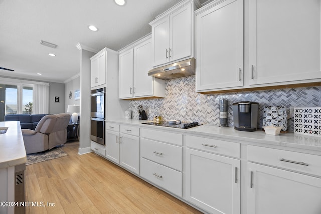 kitchen with white cabinets, light wood-type flooring, black electric cooktop, crown molding, and stainless steel double oven