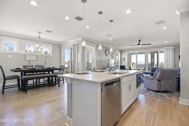 kitchen with a kitchen island with sink, hanging light fixtures, sink, white cabinetry, and appliances with stainless steel finishes