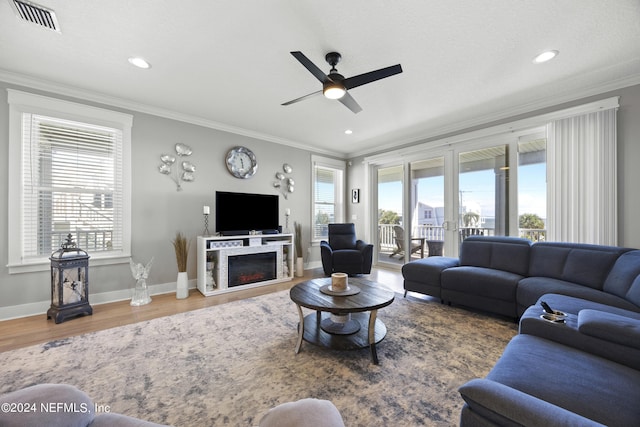 living room featuring french doors, crown molding, hardwood / wood-style flooring, and ceiling fan