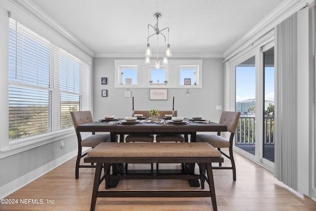 dining area featuring a wealth of natural light, crown molding, and hardwood / wood-style flooring