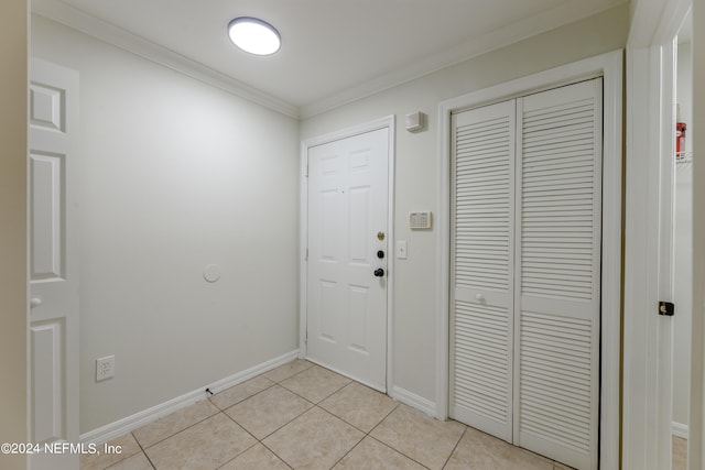 entryway featuring crown molding and light tile patterned flooring