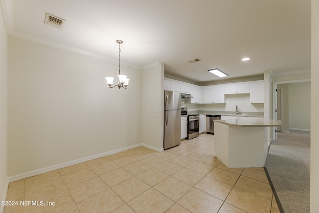 kitchen featuring appliances with stainless steel finishes, sink, hanging light fixtures, white cabinetry, and crown molding