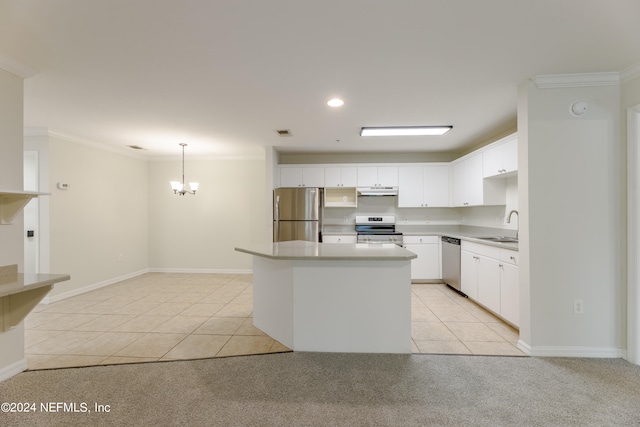 kitchen with stainless steel appliances, crown molding, sink, decorative light fixtures, and white cabinetry