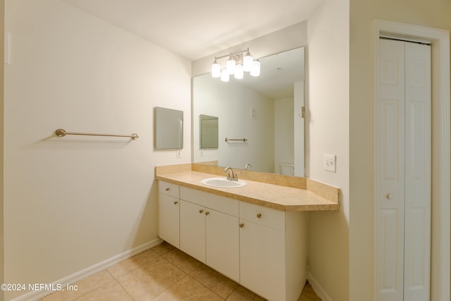 bathroom featuring vanity, toilet, and tile patterned flooring