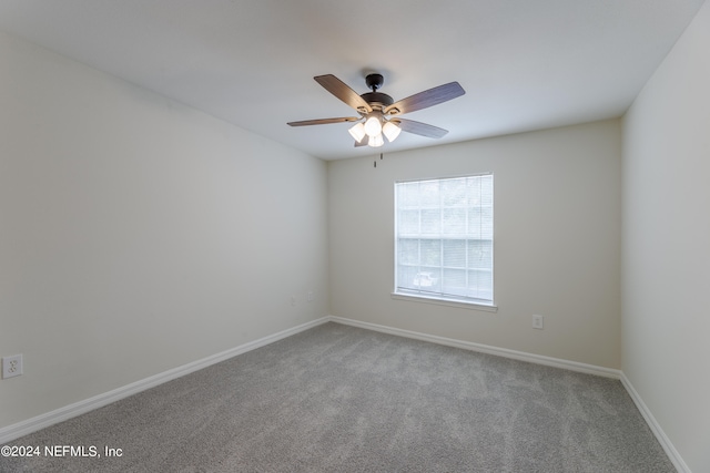 empty room with ceiling fan and carpet floors