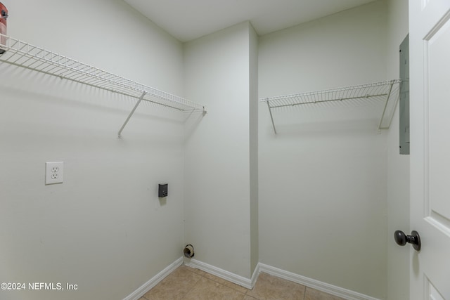 washroom featuring hookup for an electric dryer and light tile patterned floors