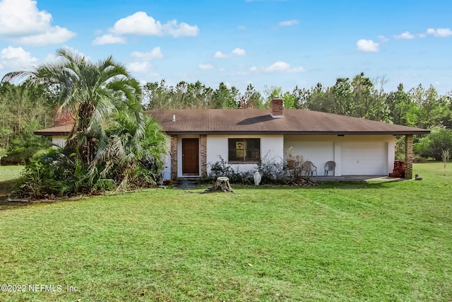 ranch-style home with a garage and a front lawn