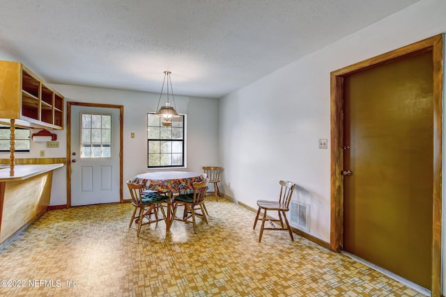 dining space with a textured ceiling