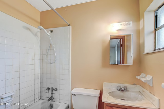 full bathroom featuring vanity, toilet, and tiled shower / bath combo