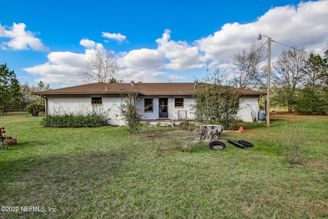 rear view of house with a yard