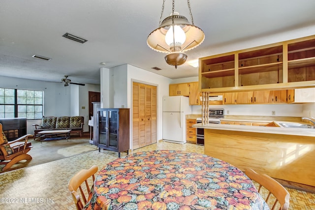 kitchen featuring electric range, ceiling fan, sink, decorative light fixtures, and white refrigerator