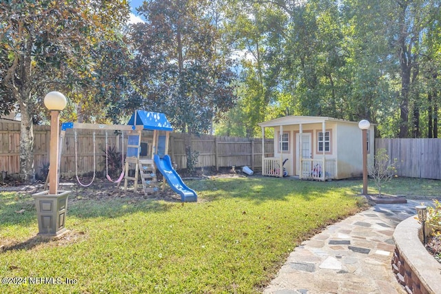 view of yard featuring a storage shed and a playground