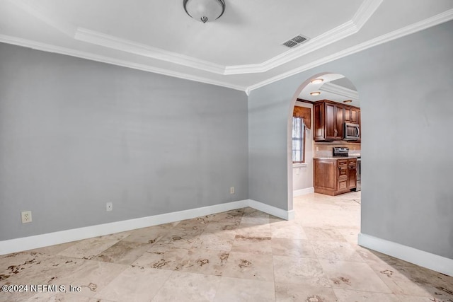 interior space featuring crown molding and a tray ceiling