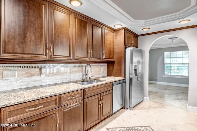 kitchen featuring decorative backsplash, stainless steel appliances, sink, and light stone counters