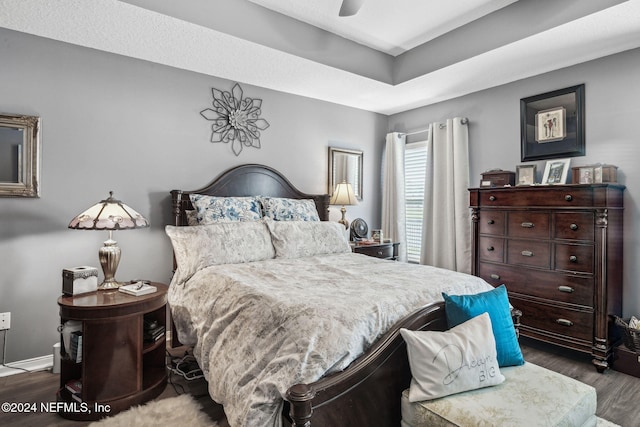 bedroom with ceiling fan and dark hardwood / wood-style flooring