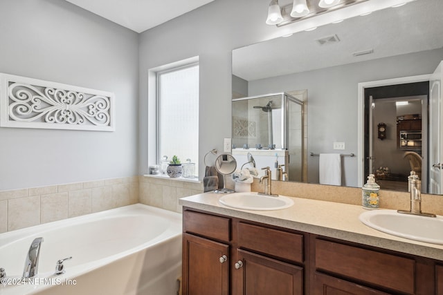 bathroom with vanity and separate shower and tub