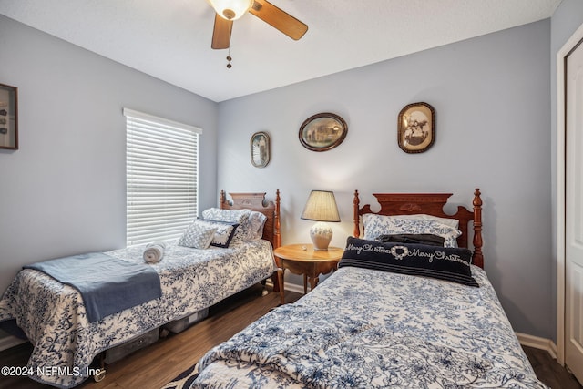 bedroom featuring dark hardwood / wood-style flooring and ceiling fan