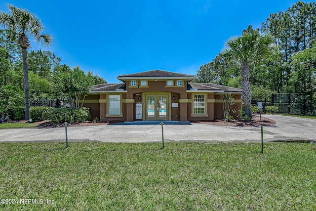 view of front of house featuring french doors and a front yard