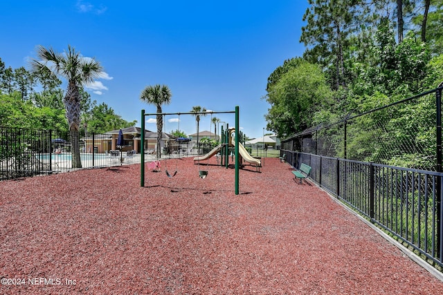 view of playground featuring a community pool